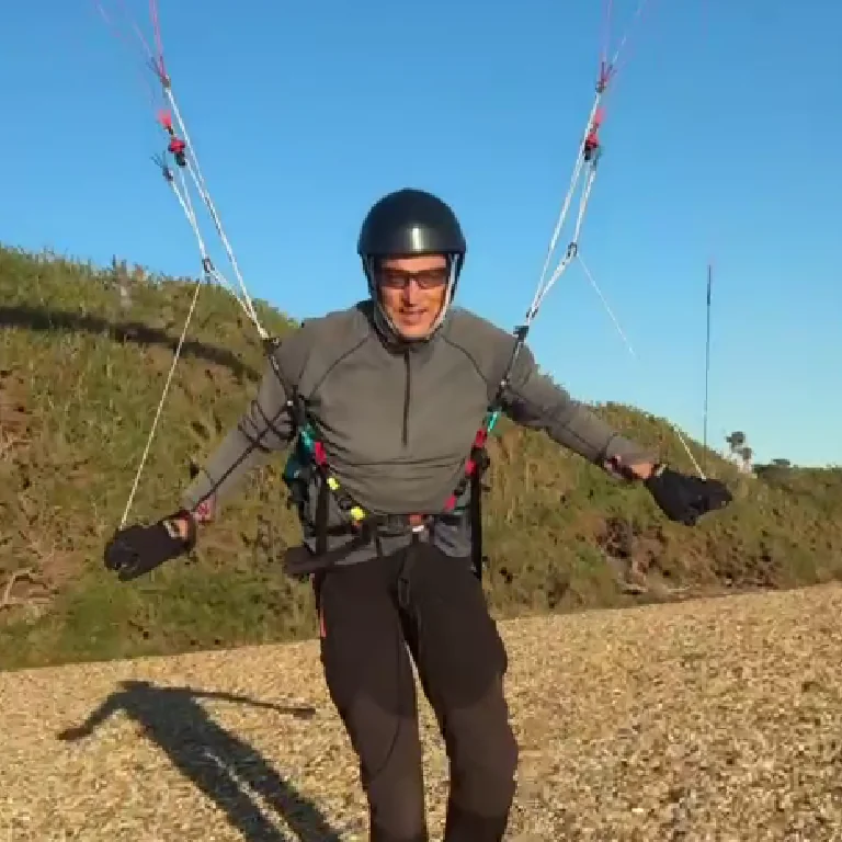 Goran Oberg controlling a parakite while wearing a helmet and flying harness
