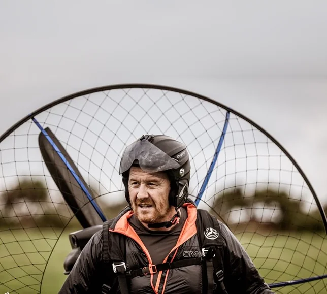 Scott Heffield wearing his helmet and paramotor harness